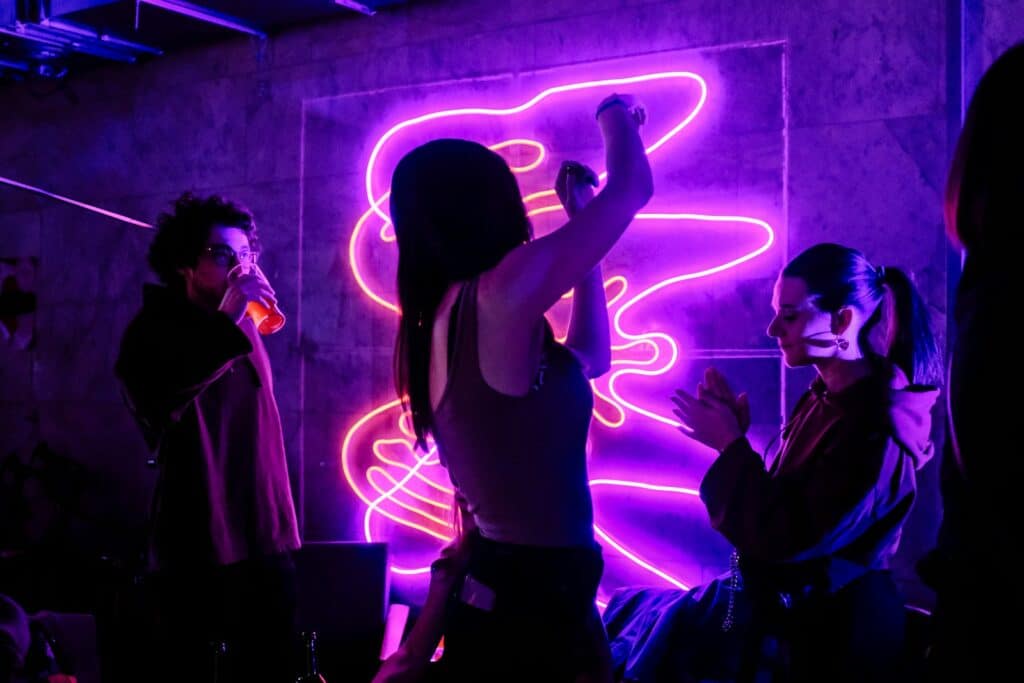 woman in black tank top singing on stage